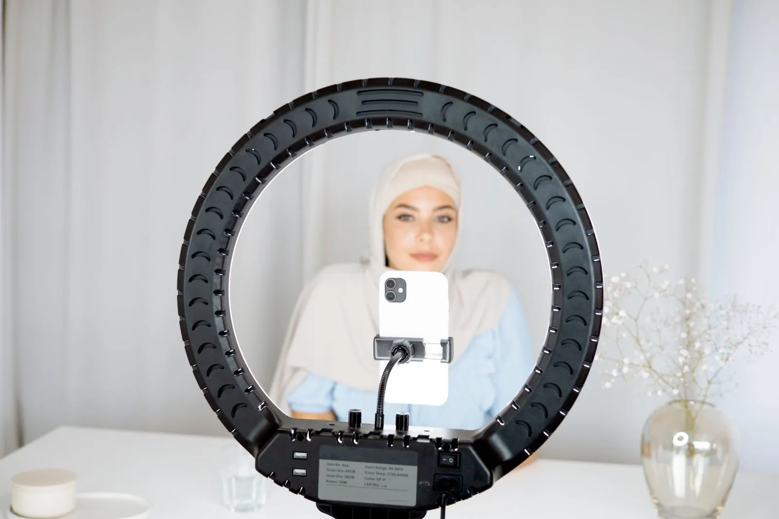 Creator filming content with a ring light for a brand campaign